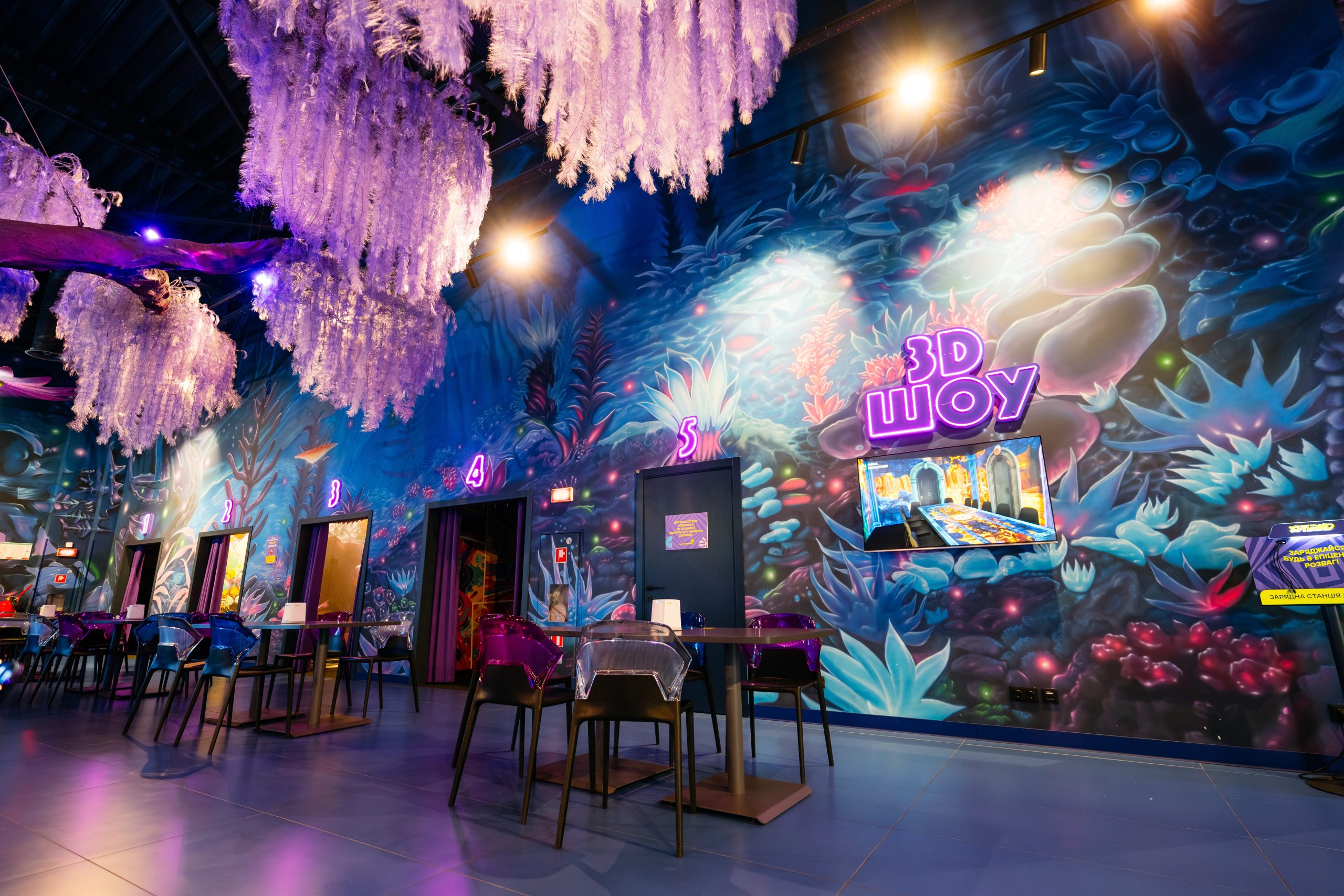 Large-scale fantasy wall mural with luminescent jellyfish and crystals creating immersive dining experience in entertainment center with custom interior wall art