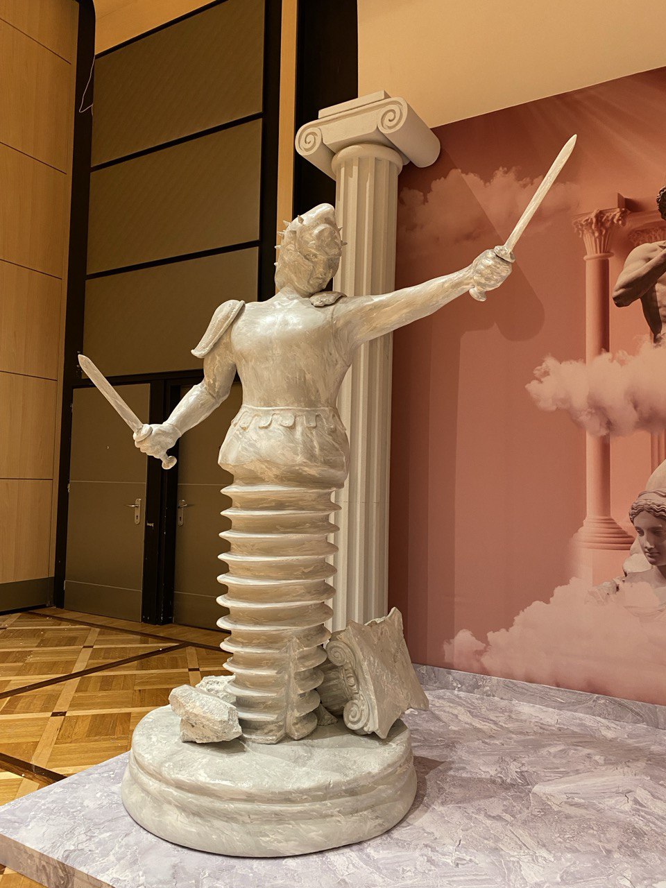 Handcrafted foam gladiator sculpture with classical Roman columns for conference photo zone