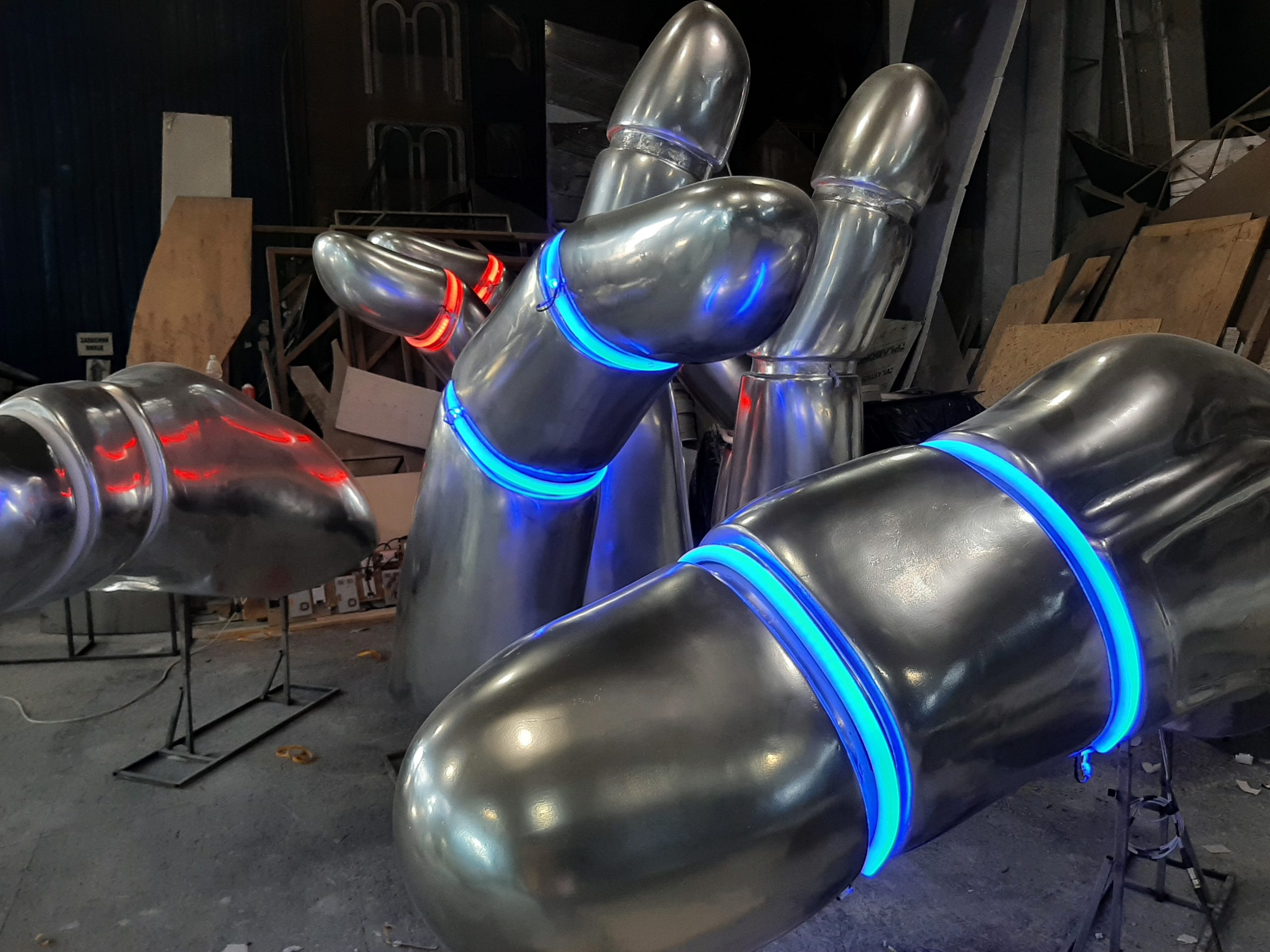 Close-up view of metal hand sculpture showing detailed finger joint construction and polished finish