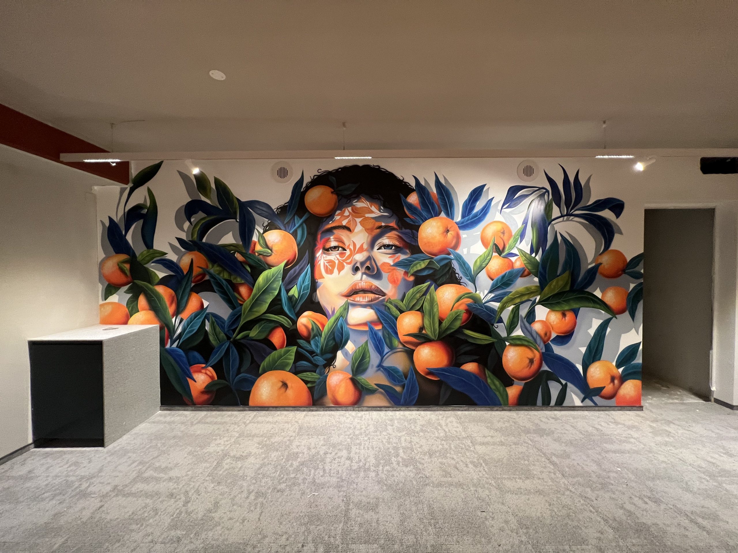 Custom wall mural installation in Paphos office space showing botanical design integrated with modern interior