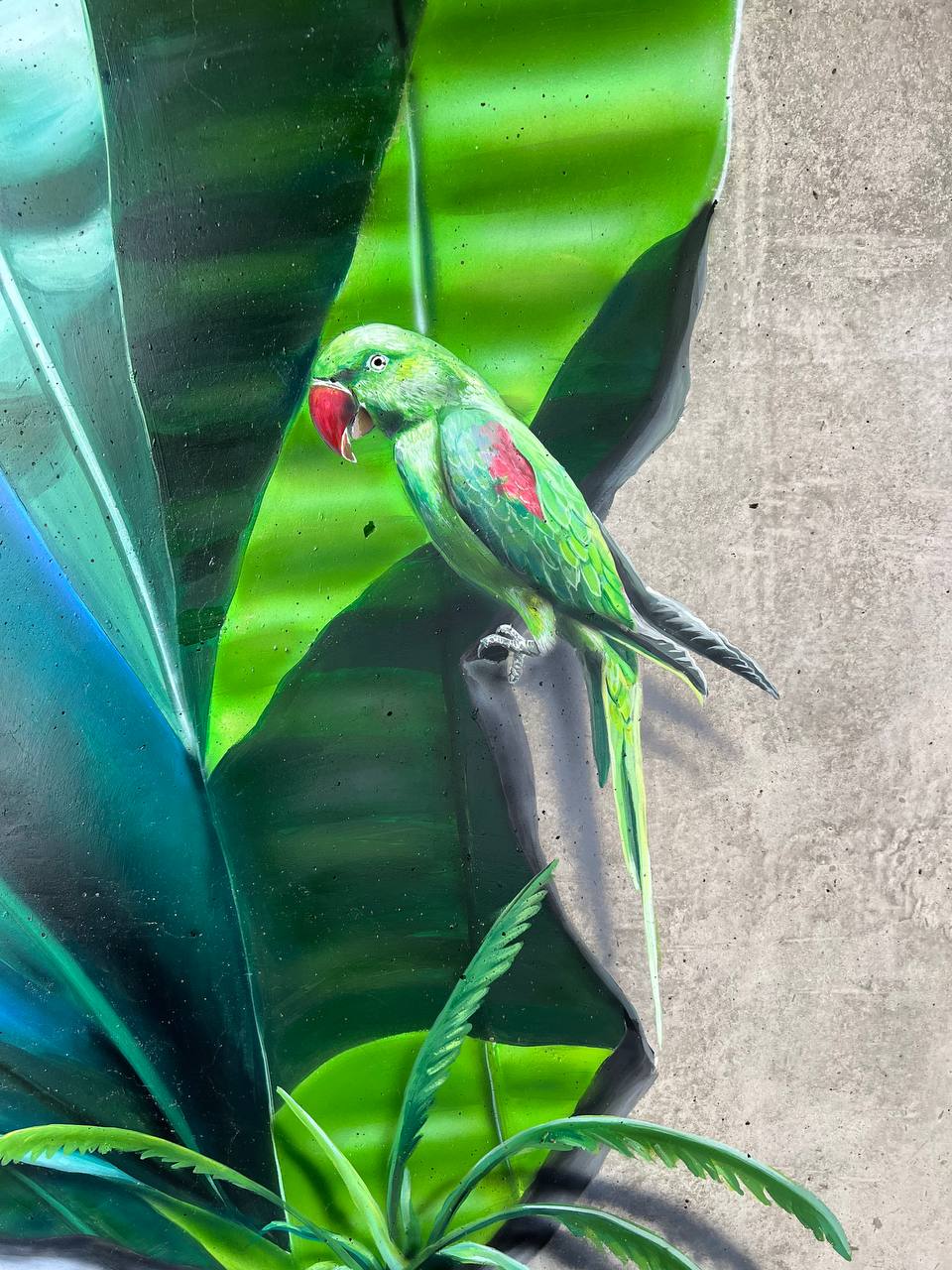 Photorealistic detail of green and red parrot perched on banana leaf in tropical terrace mural