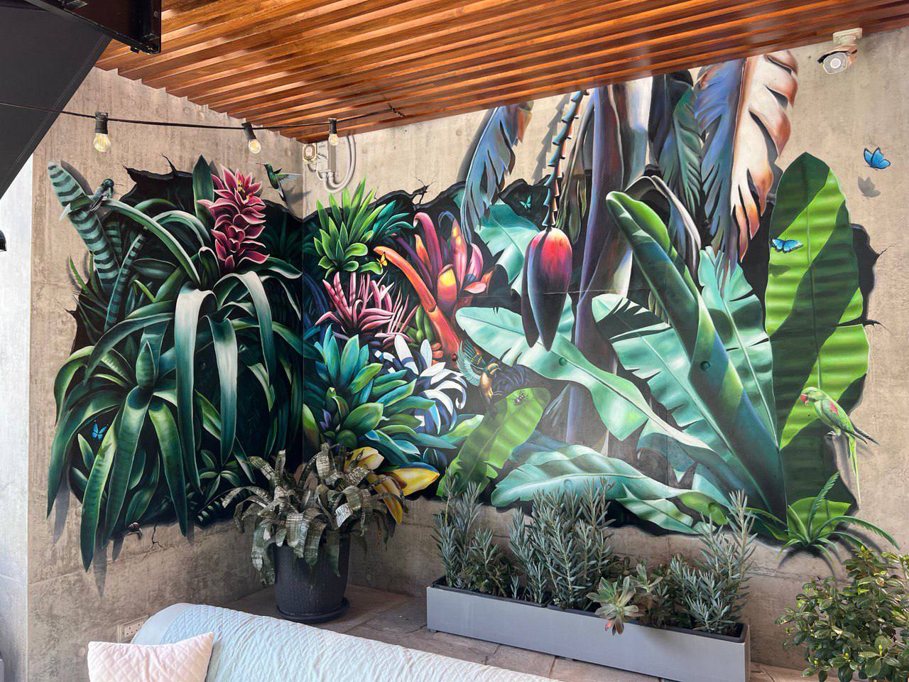 Large-scale tropical botanical mural on covered terrace featuring hyperrealistic exotic plants and flowers with 3D illusion effect