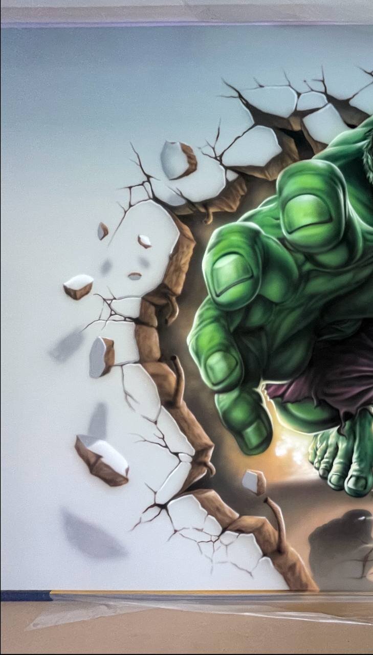 Close-up detail of 3D wall mural showing realistic cracked wall debris and breaking effect