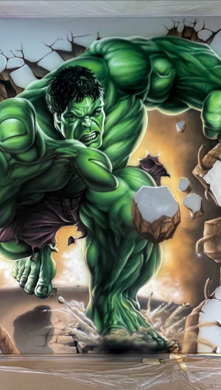 Full view of 3D superhero mural in kids room with breaking wall illusion and protective floor covering