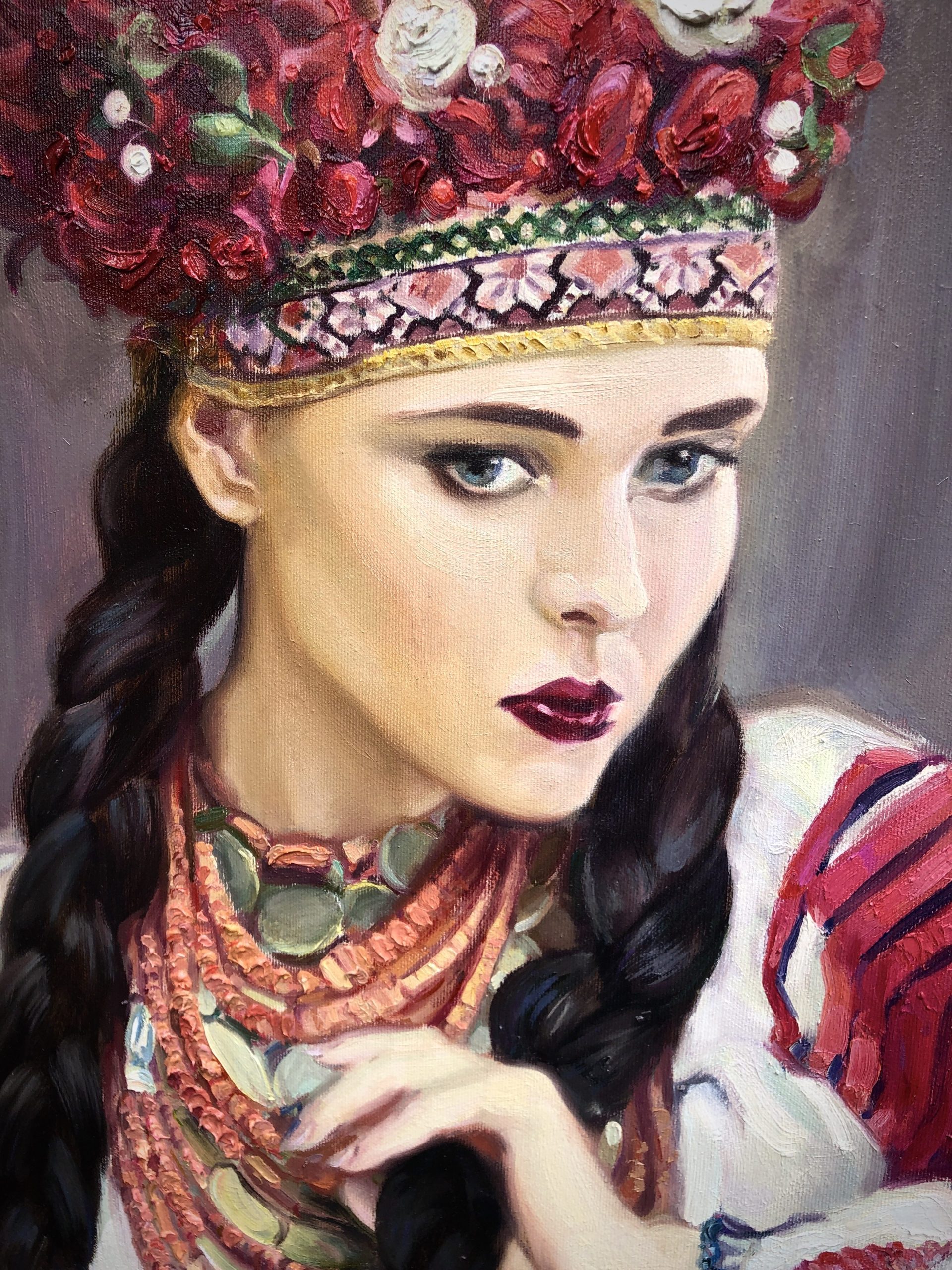 Detailed close-up of hand-painted portrait showing layered coral necklaces, coin jewelry, traditional embroidered sleeve, and richly textured floral headpiece rendered in oil with visible impasto brushwork