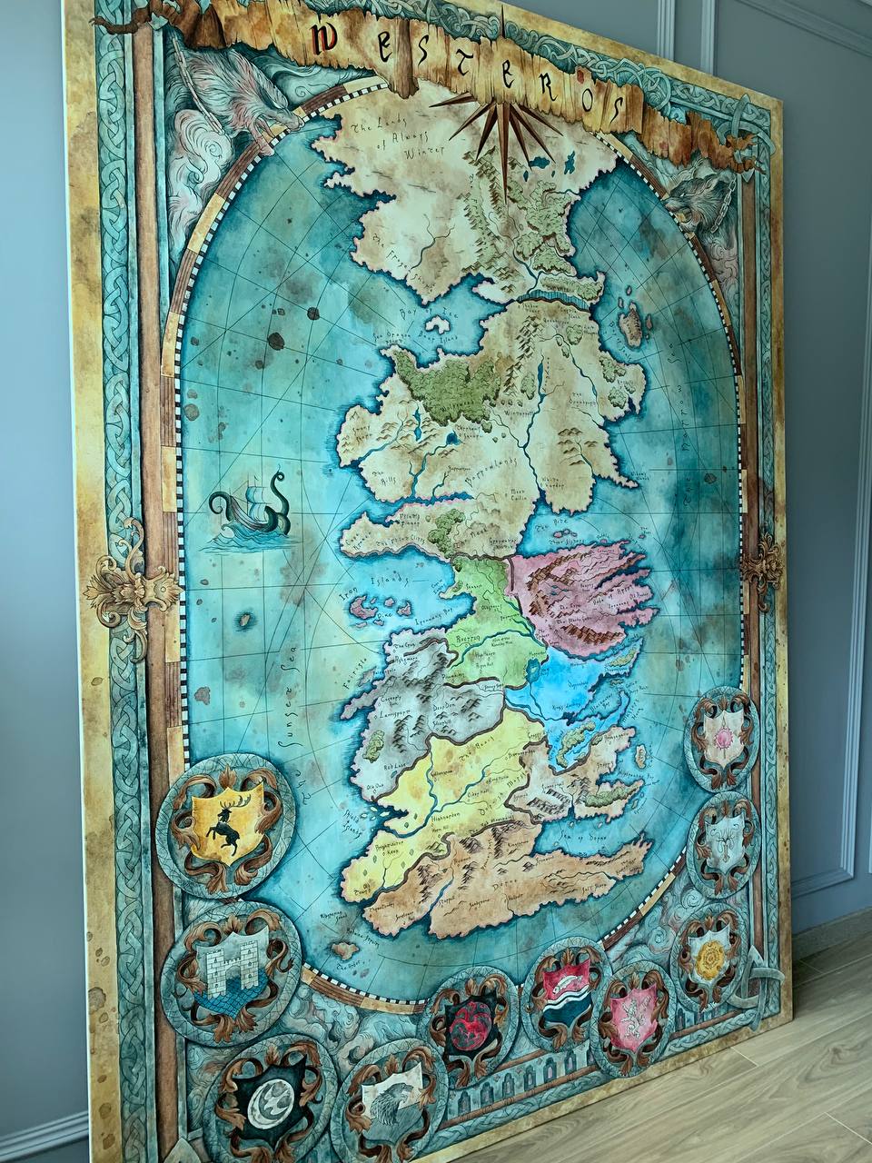 Detailed view of hand-painted Westeros map canvas showing Great House sigils and cartographic detail